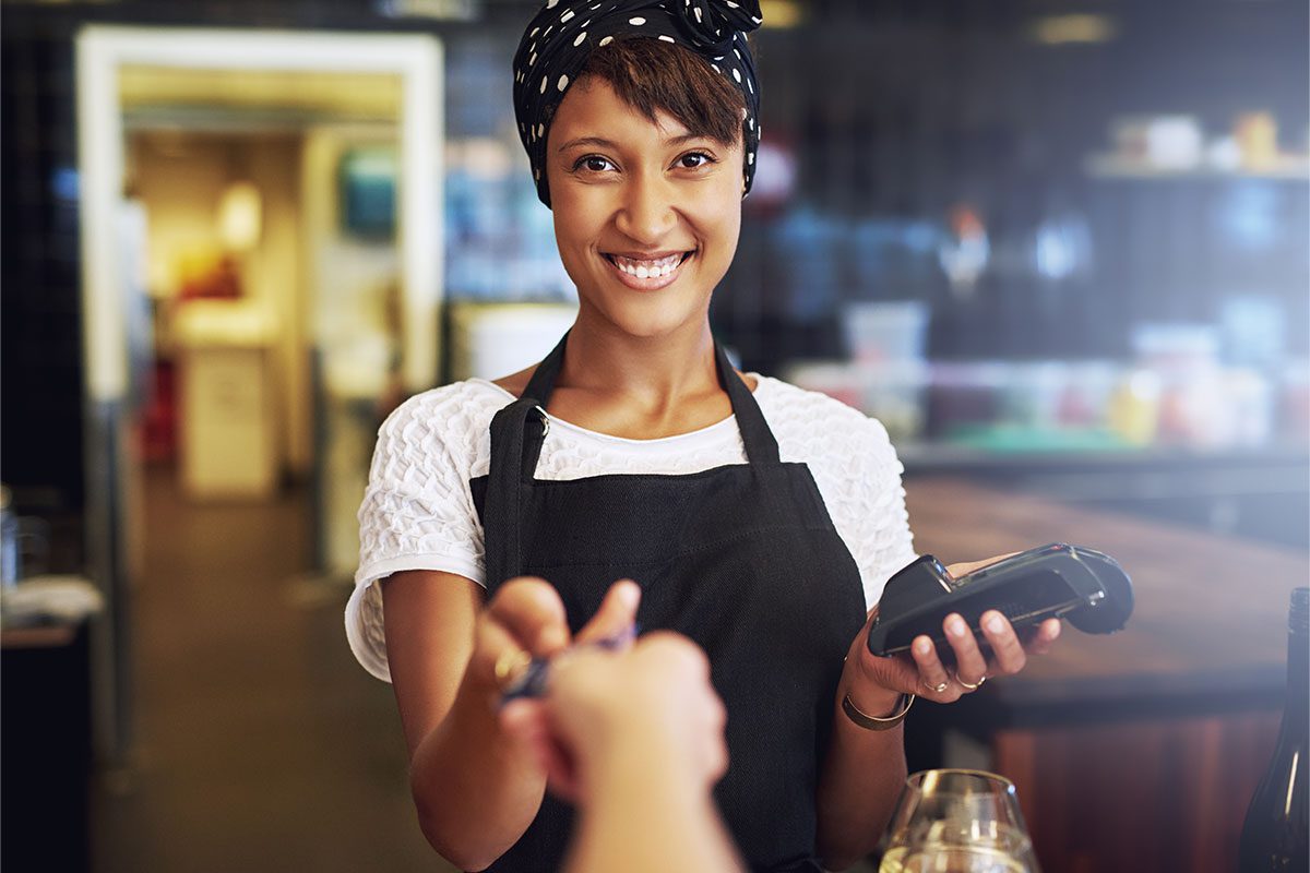 Smiling Waitress Taking a Credit Card