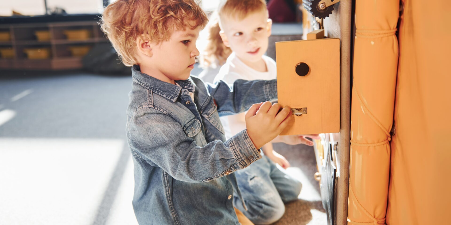 Children have fun in playroom near the wall