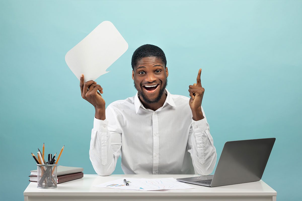 Black man having an Eureka! moment at his working desk