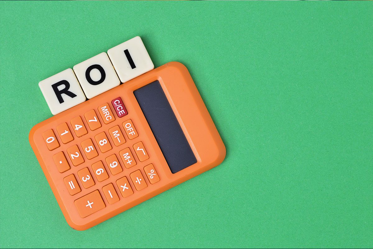 Scrabble Letters With Text Roi Arranged Beside A Calculator